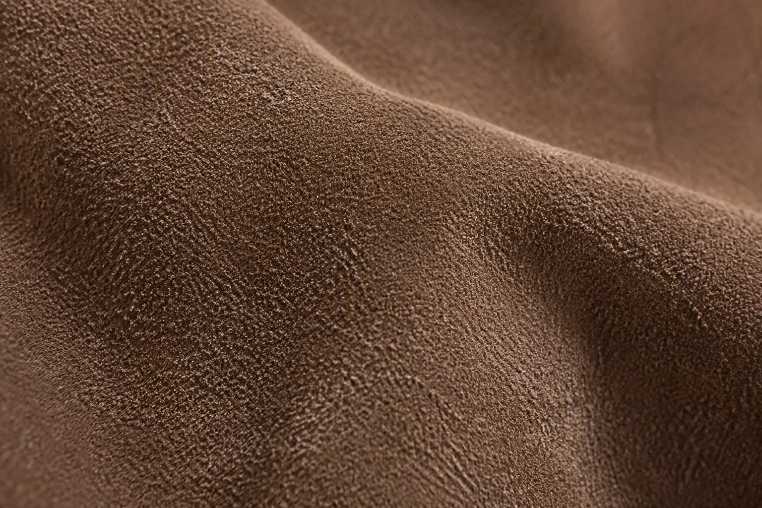 Close-up of suede leather showing its soft, velvety nap and fine fibers