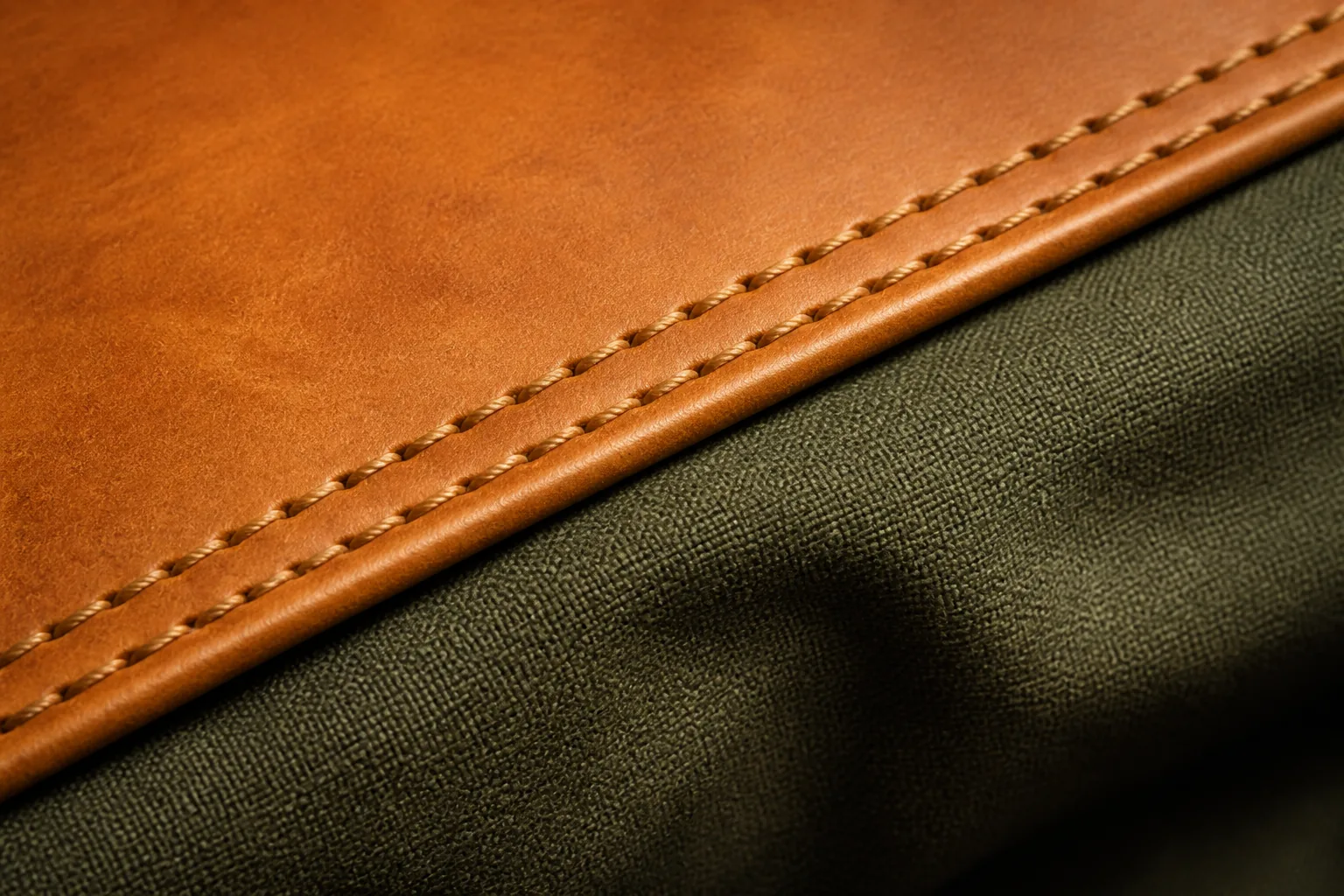 A leather trim panel joined to waxed canvas with two rows of stitching