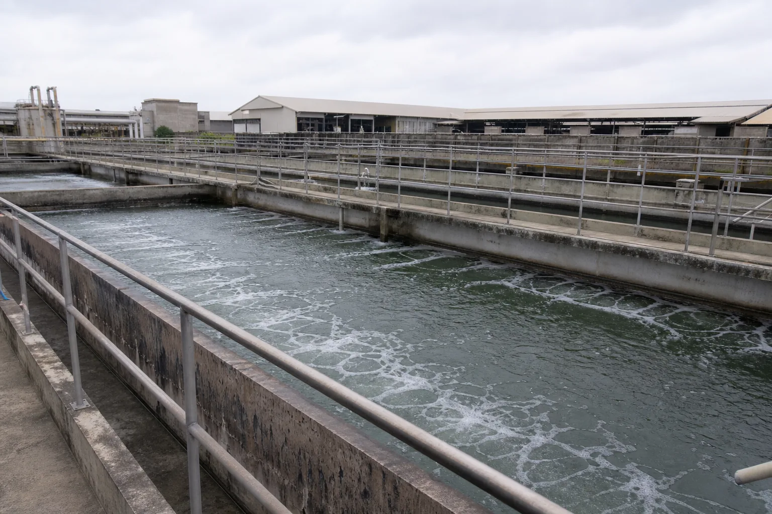 A tannery water treatment area with settling tanks and steel railings