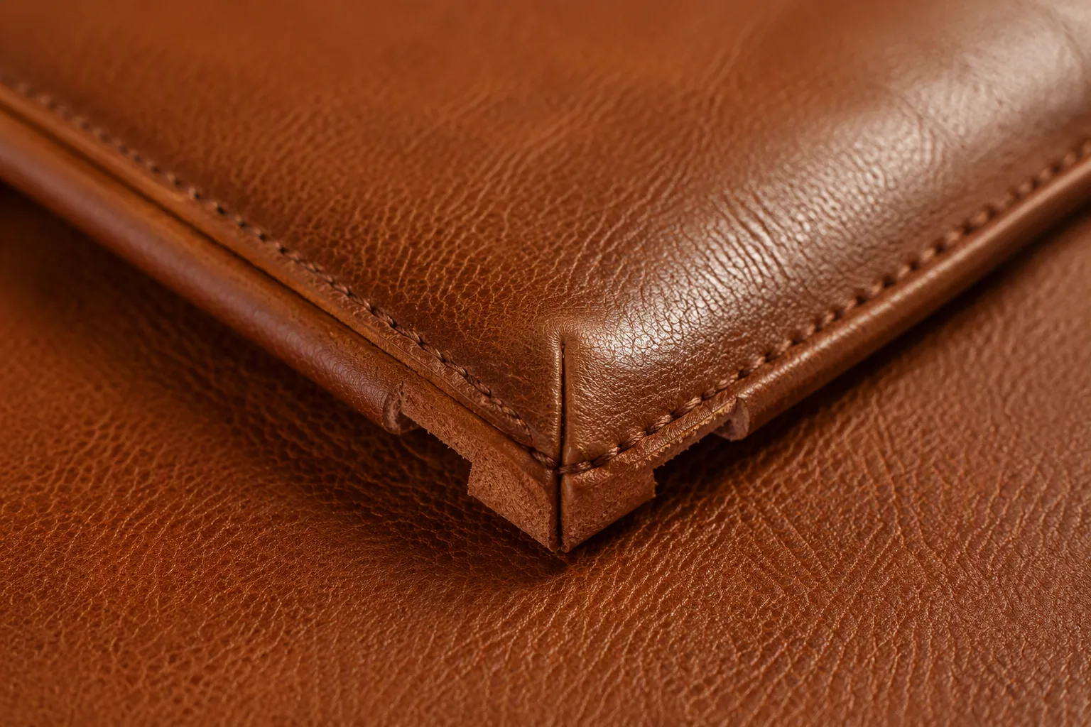 A turned leather bag corner pressed flat after the seam allowance was clipped and reduced