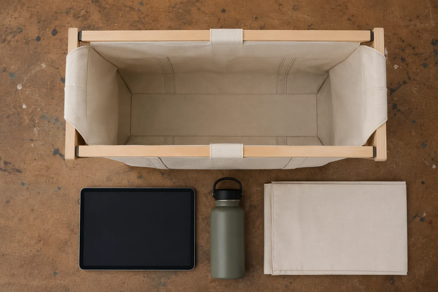 A canvas mock-up held open with reference items beside it